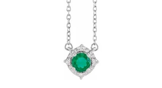 a sterling silver pendant necklace featuring a round cut emerald with a diamond halo