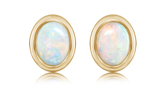 a pair of yellow gold stud earrings featuring opals