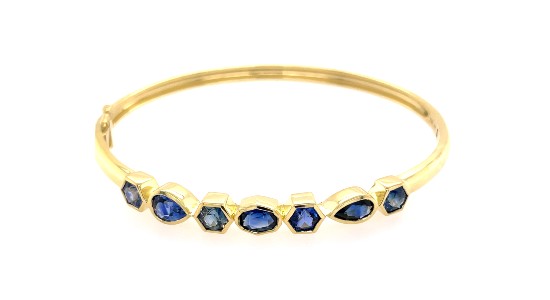 a yellow gold bangle featuring different shapes of sapphires