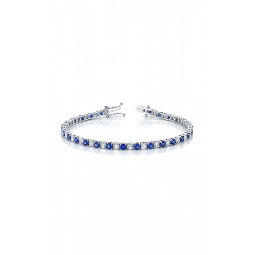 A white gold tennis bracelet with alternating blue sapphires and diamonds.