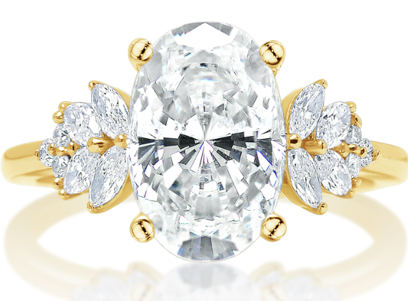 A yellow gold side stone engagement ring with oval center diamond.