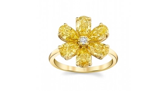 a yellow gold flower ring with yellow diamonds