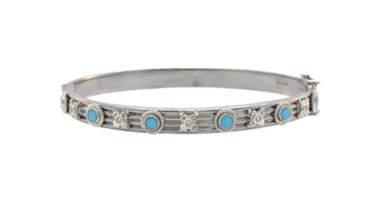 a white gold bangle bracelet with blue stones