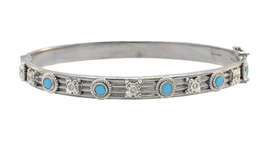 a white gold bangle bracelet featuring diamonds and turquoise