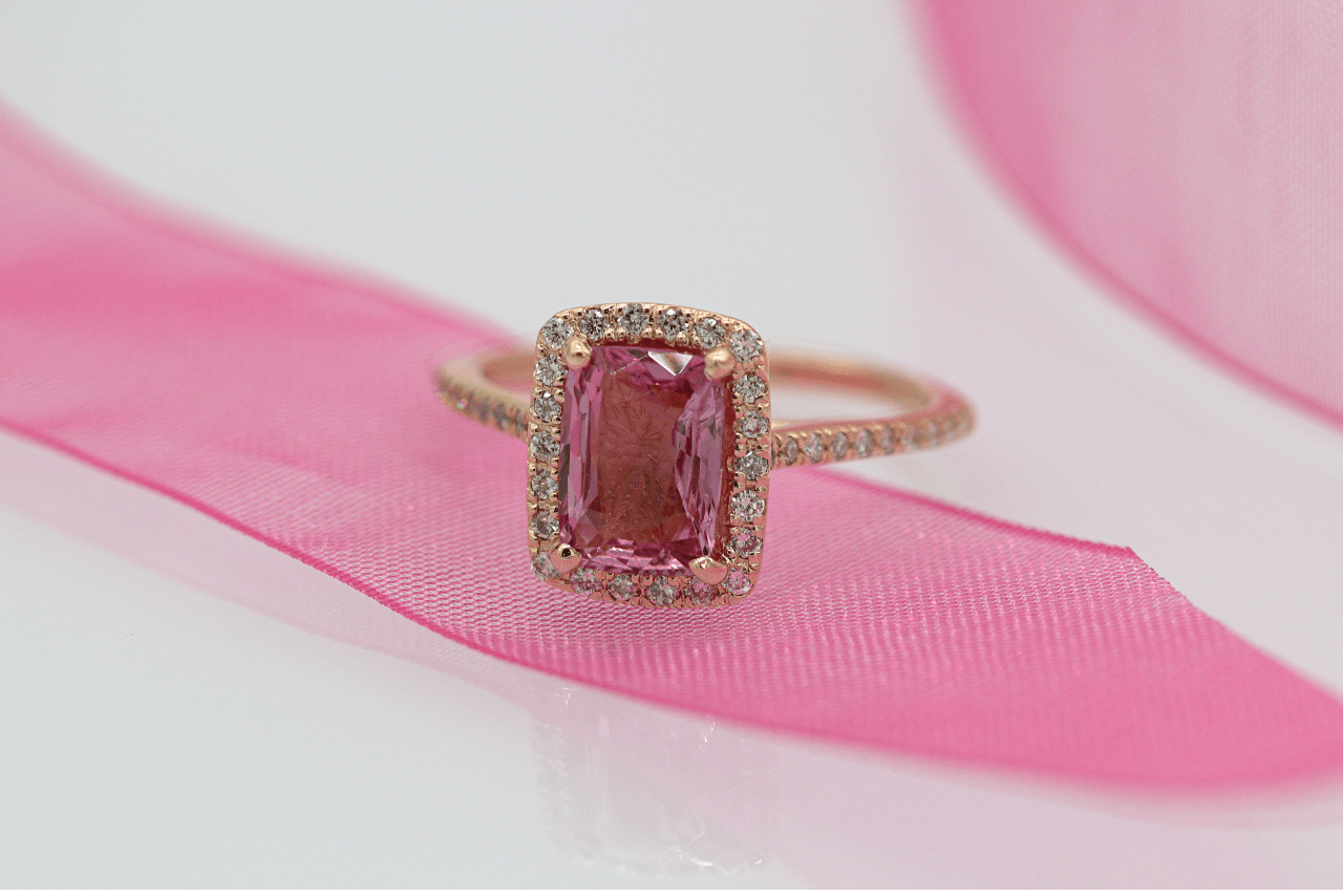A rose gold fashion ring with a large emerald cut pink tourmaline center stone A rose gold fashion ring with a large emerald cut pink tourmaline center stone