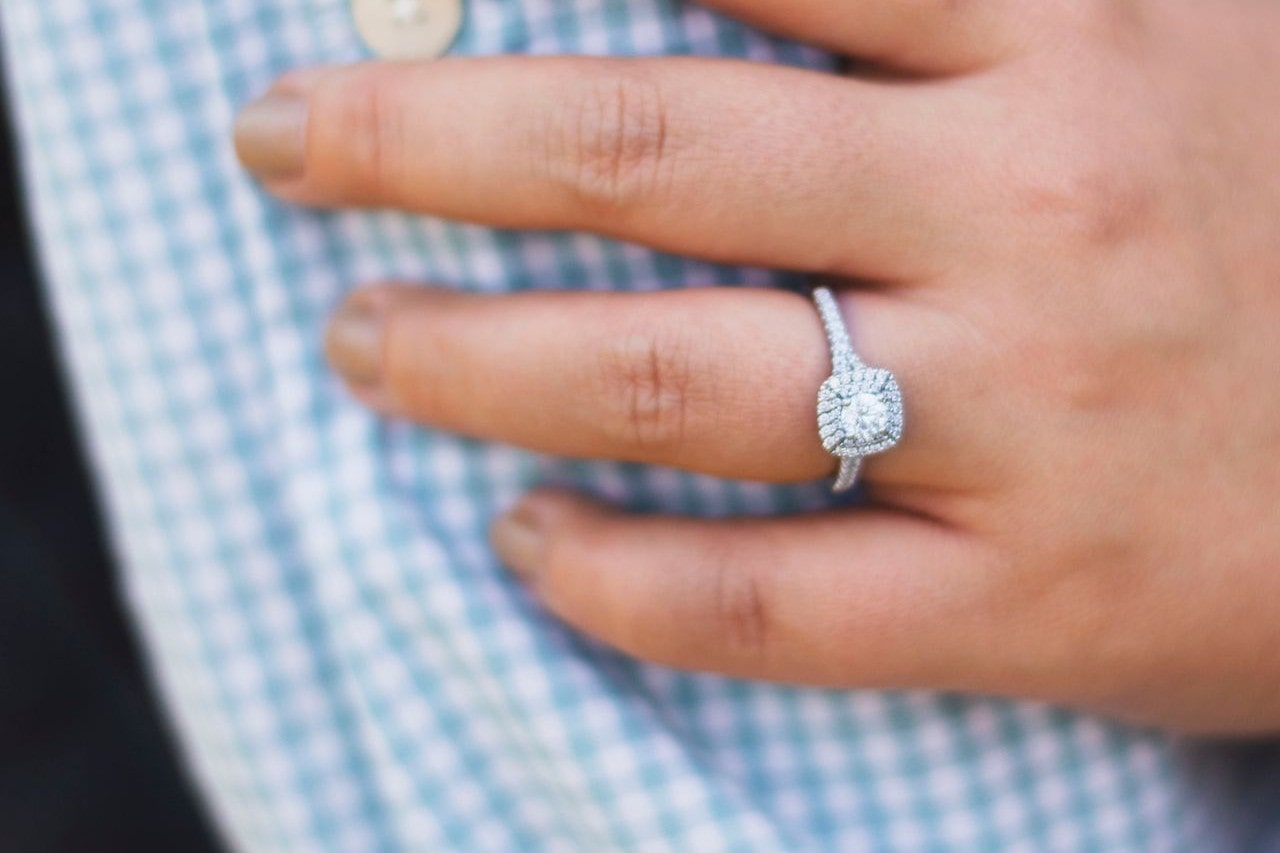 Engagement ring with a brilliant halo and pave side stone setting