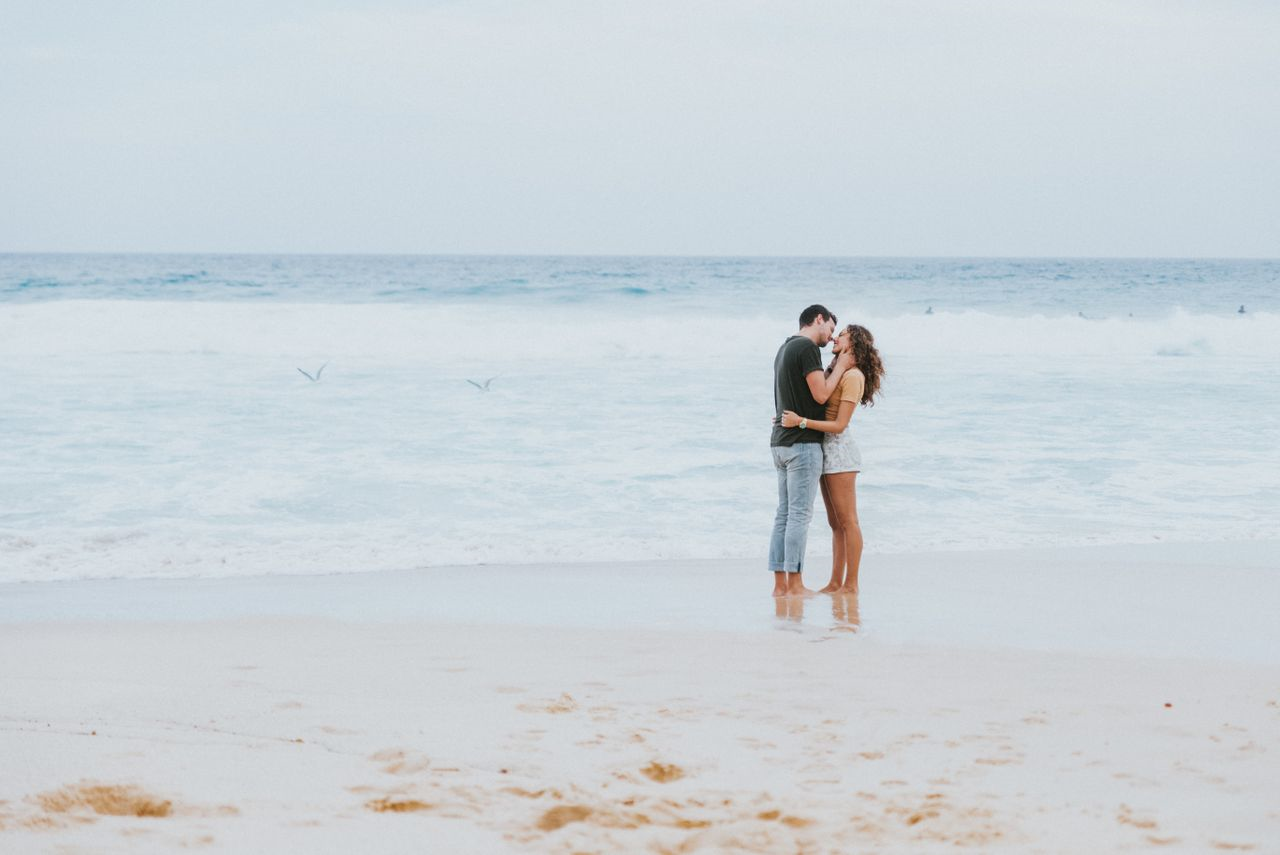 Romantic couple standing on a beach embracing