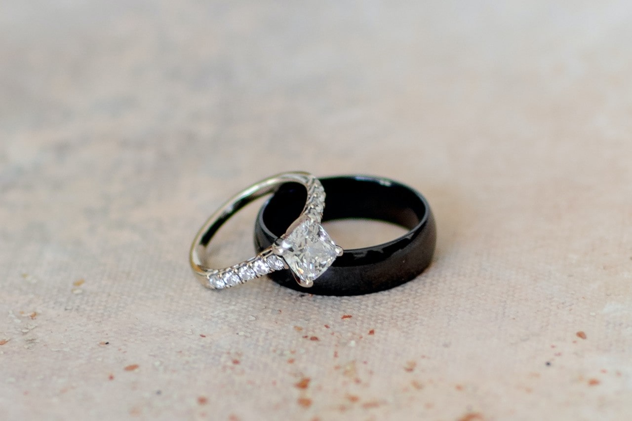 A princess cut center stone with round diamonds along the side