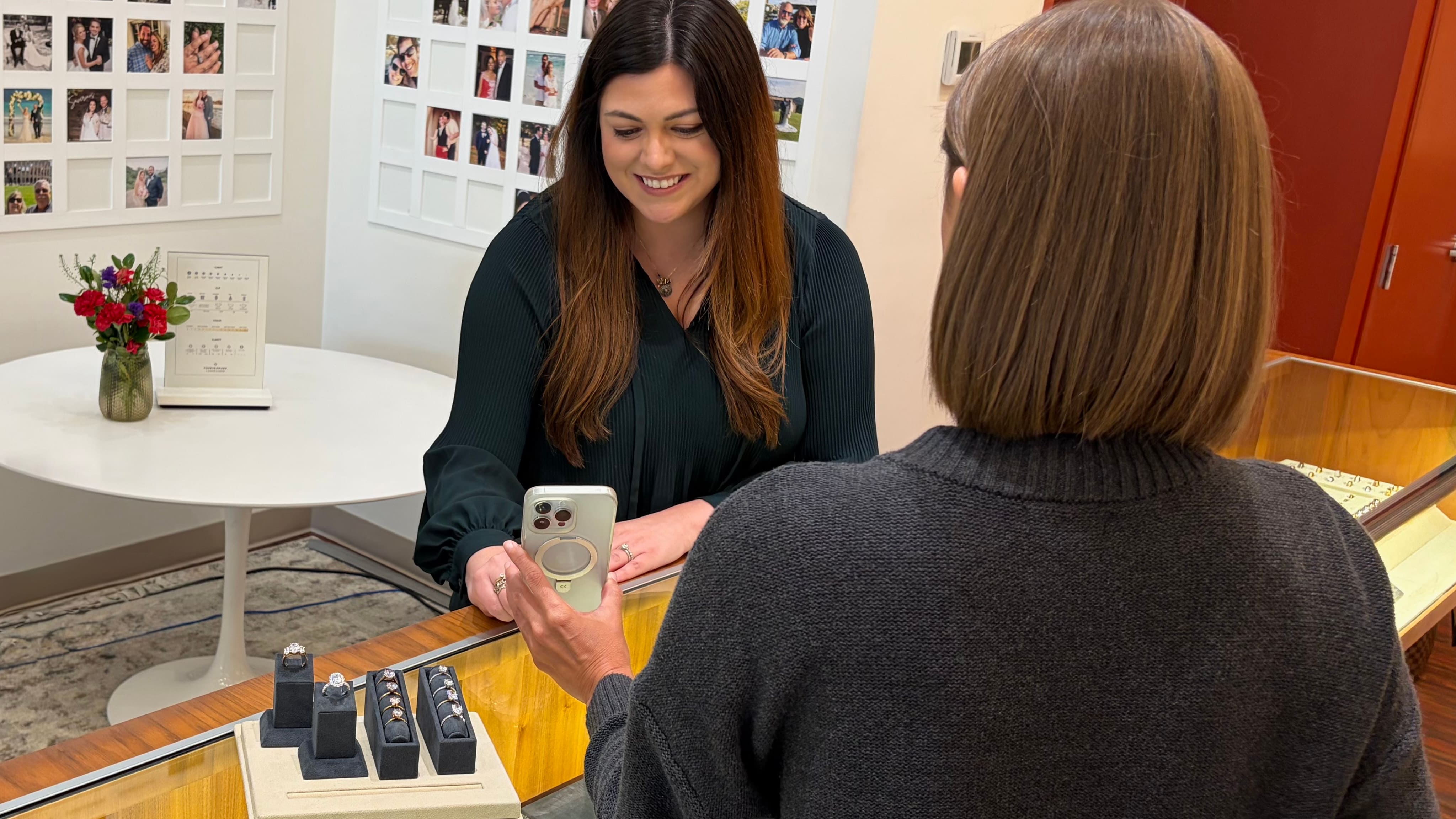 A photo banner featuring a jeweler and a customer sharing an engagement ring vision
