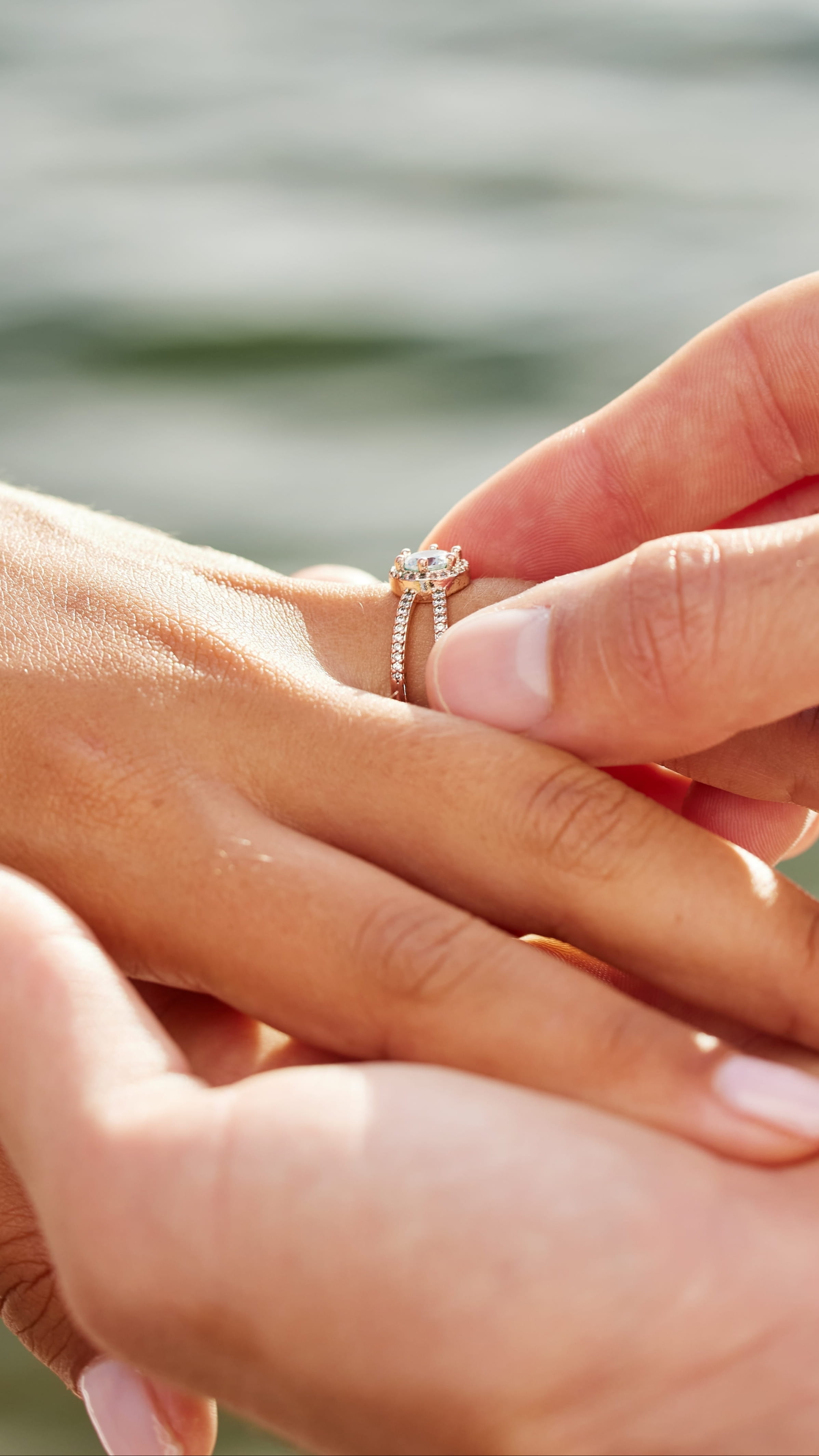 Banner of a man placing an engagement ring on a woman's finger